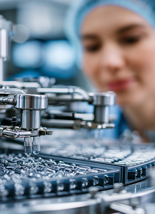 Scientists and engineers working in a pharmaceutical manufacturing environment focused on medicine development and supply