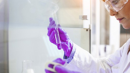 scientist in lab with beaker