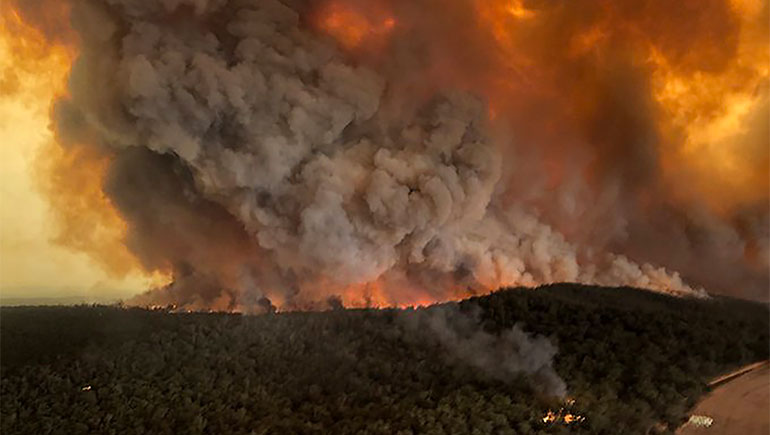 Fires rage under plumes of smoke in Bairnsdale, Australia, in this Dec. 30, 2019, photo from the Associated Press.