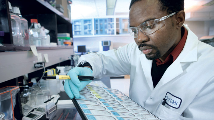 Scientist studying results with gloves