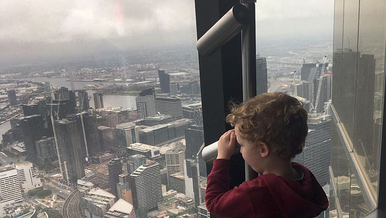 Three-year-old Lowen looks out over the haze of smoke from nearby bushfires shrouding Melbourne. 