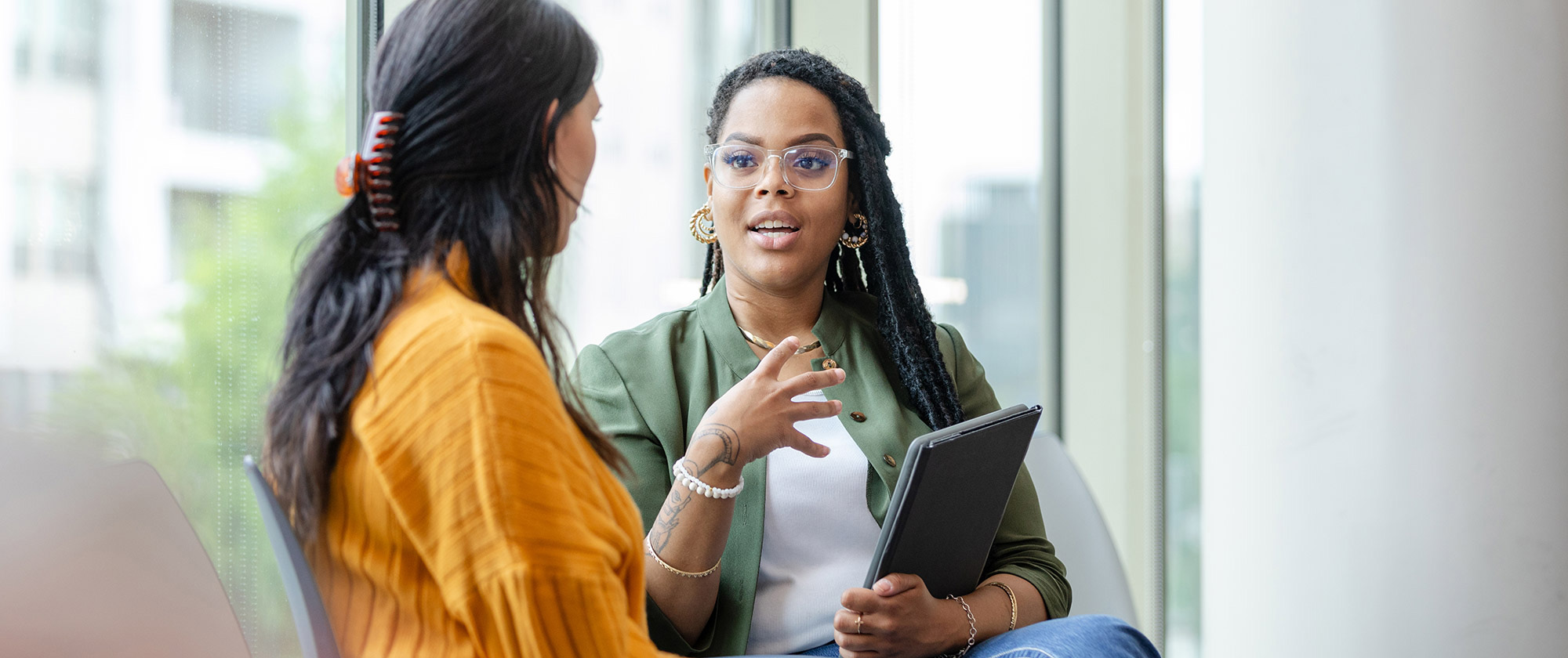 Two women in an interior environment having a conversation