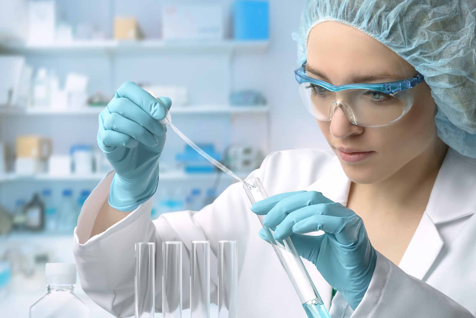 female scientist in laboratory filling beaker female scientist in laboratory filling beaker